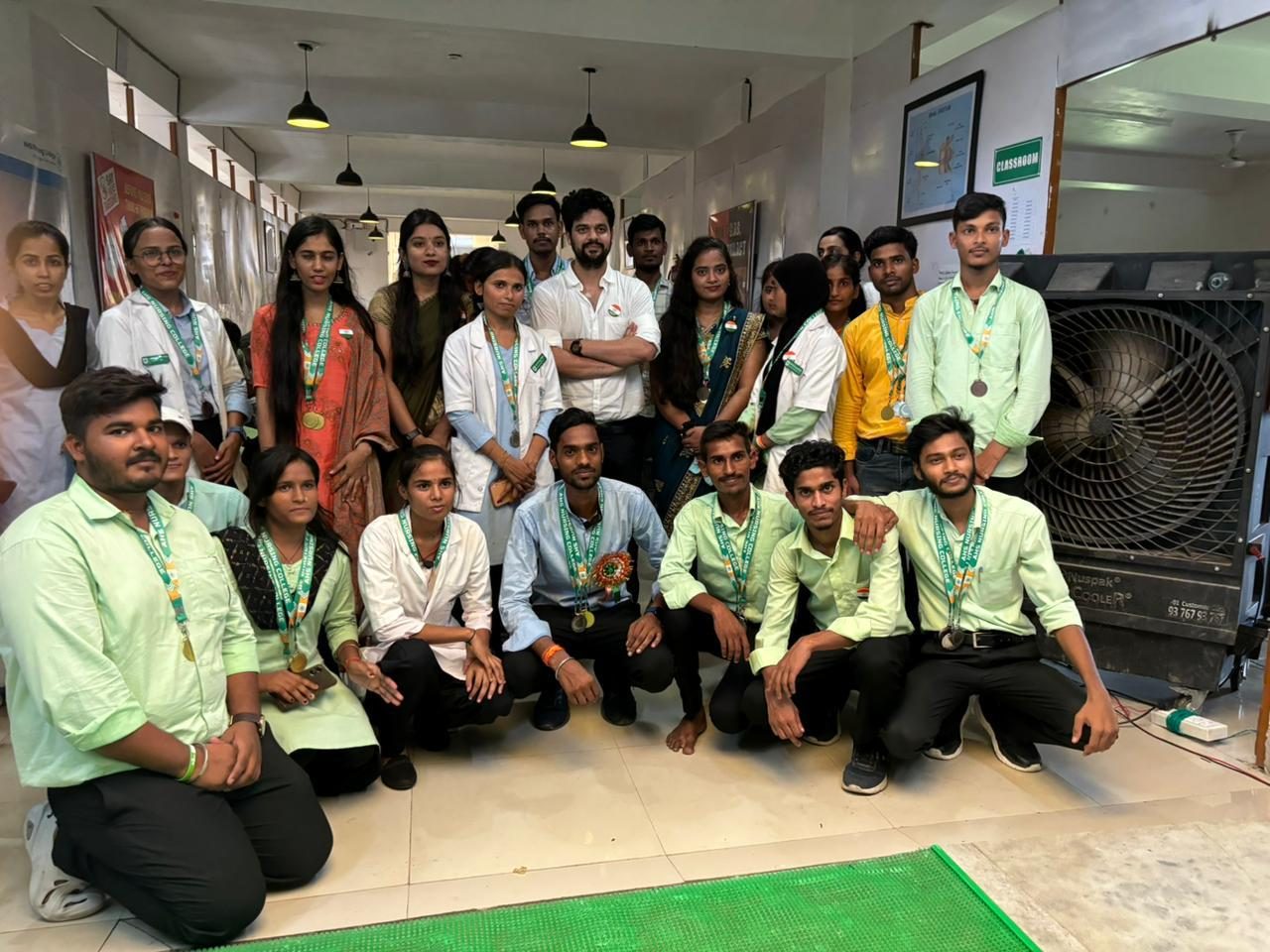 Students and faculty in the tricolour-decorated hall