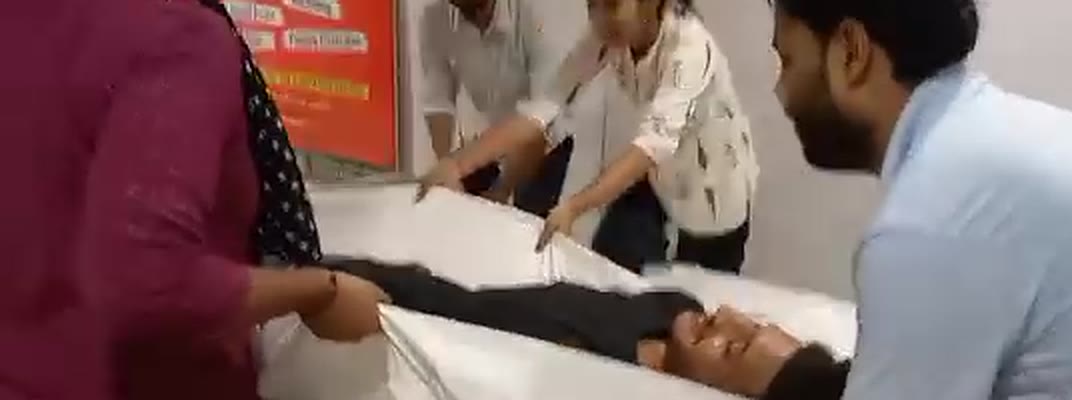 Students moving a casualty with a draw sheet