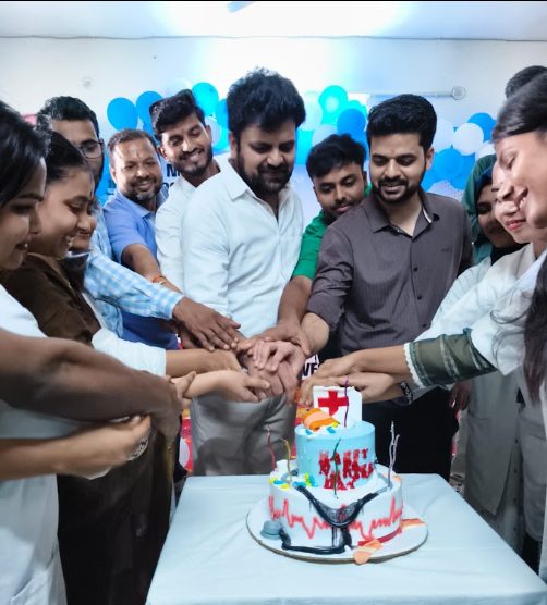 Faculty and students cutting the Nurses Day cake