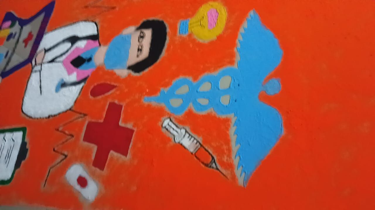 Rangoli showing a doctor, nurse and caduceus