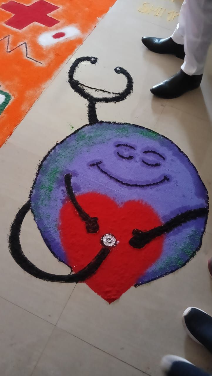 Rangoli of a smiling globe with a stethoscope