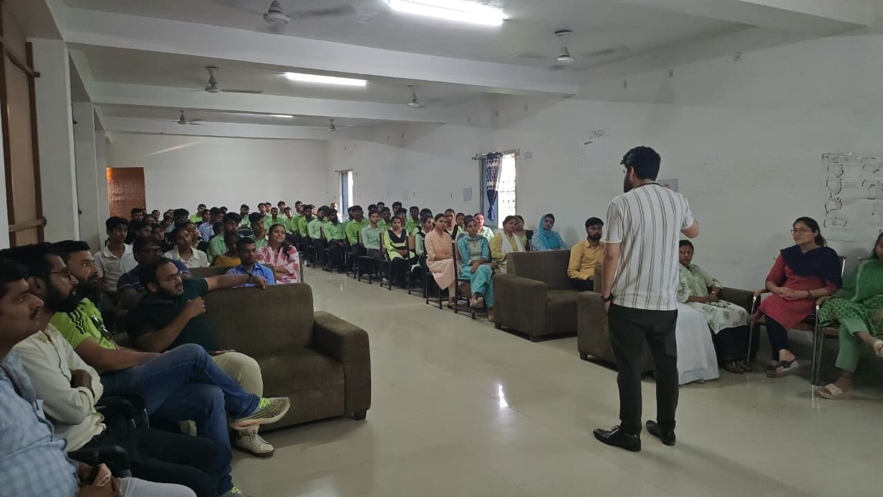 A speaker addressing students and faculty