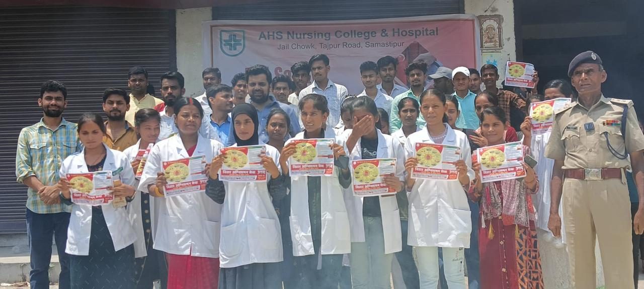 Students holding Bihar Fire Service awareness leaflets with a fire officer