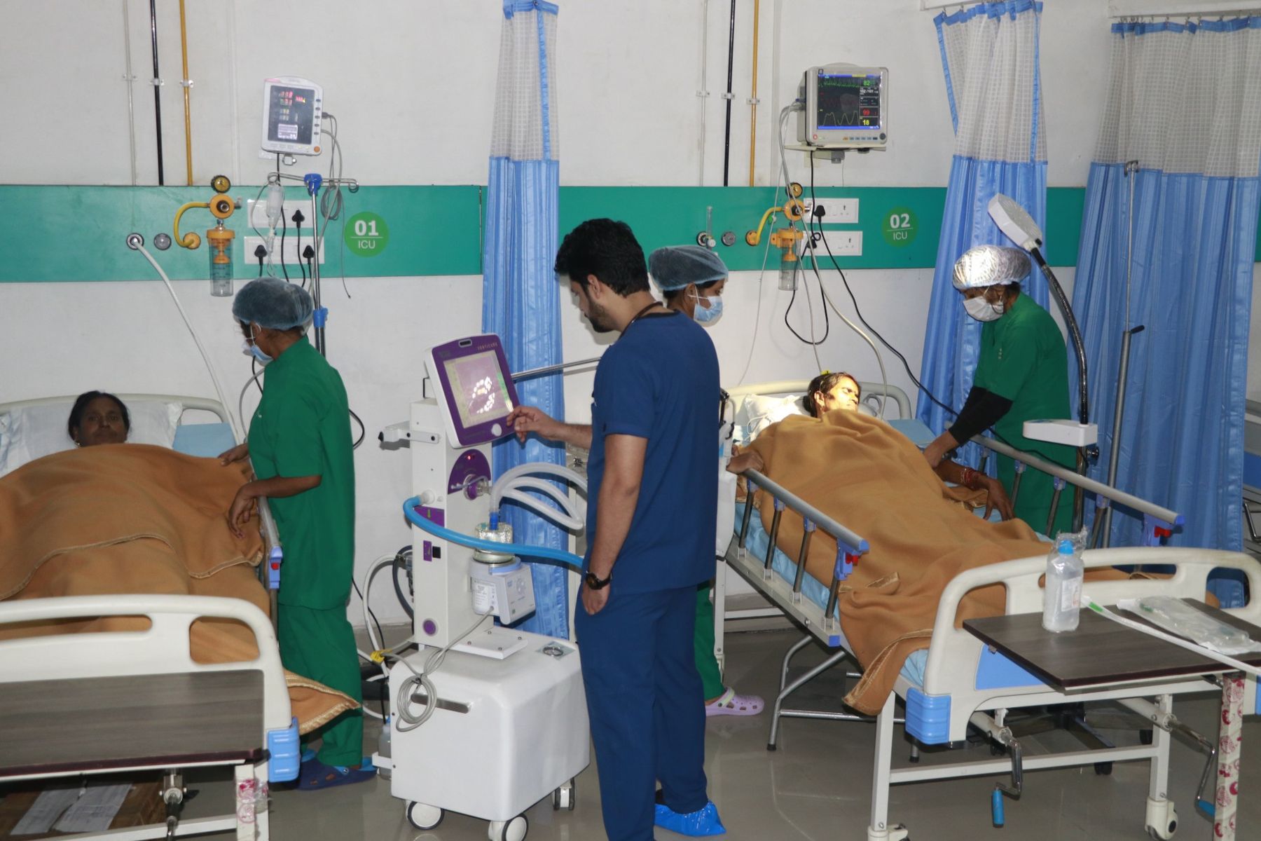 Doctor and nurses caring for patients in the ICU