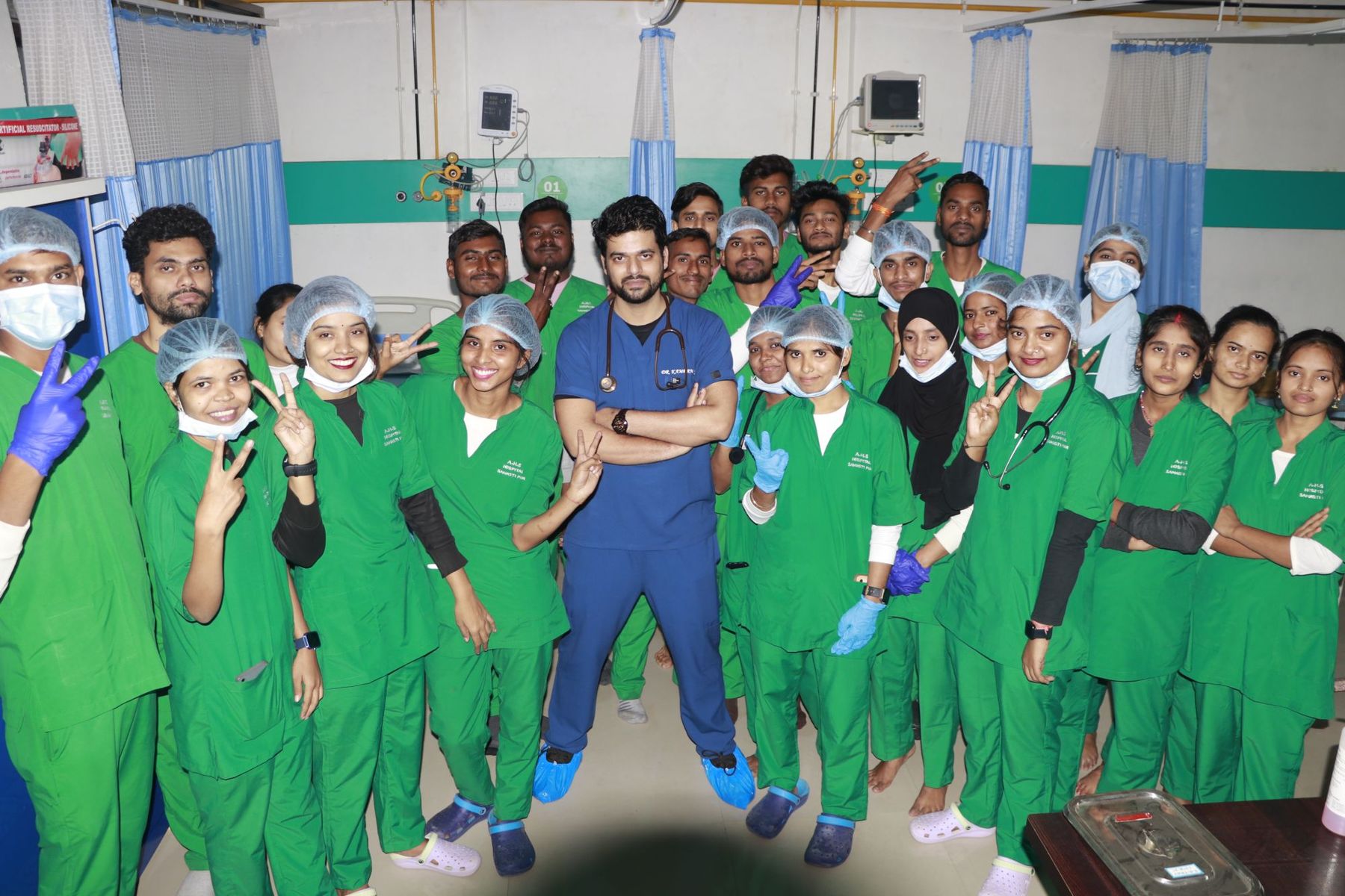 AHS nursing students in scrubs with a doctor in the ICU of AHS Global Hospital